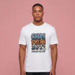 A man wearing a white t-shirt featuring the Chai Premi 24/7 Fueling The Day graphic.
