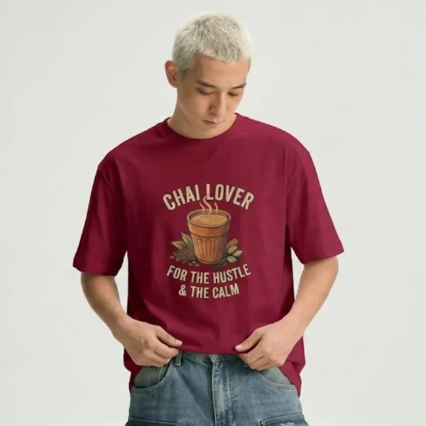 A man wearing a black t-shirt with a Chai Lover For The Hustle & The Calm graphic design.