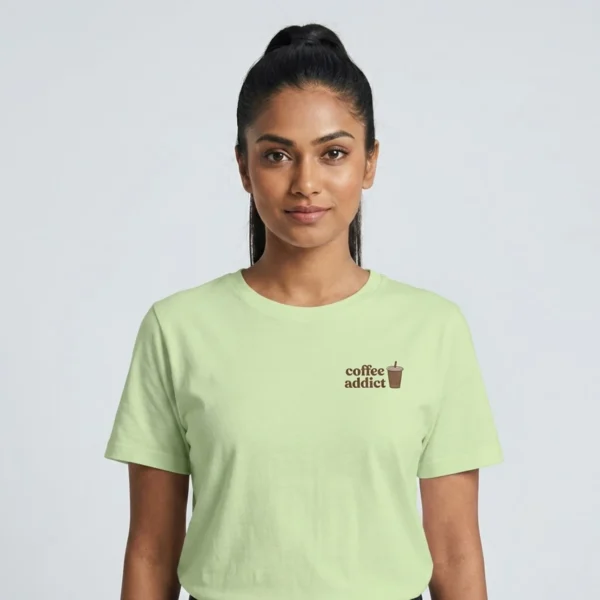 Model facing camera wearing a coffee addict t-shirt with minimal chest cup icon