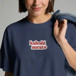 Close-up chest graphic detail of the kaleshi aurat t-shirt featuring retro font and kiss mark patch art