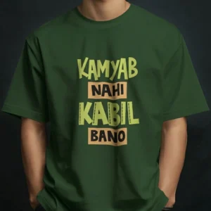 Man wearing a t-shirt featuring bold typography with the text KAMYAB NAHI KABIL BANO