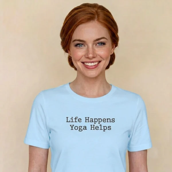Close-up chest graphic detail of the life happens yoga helps t-shirt featuring centered dark typewriter font