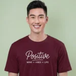 Close-up chest view of the positive mind vibes life t shirt script and mantra typography